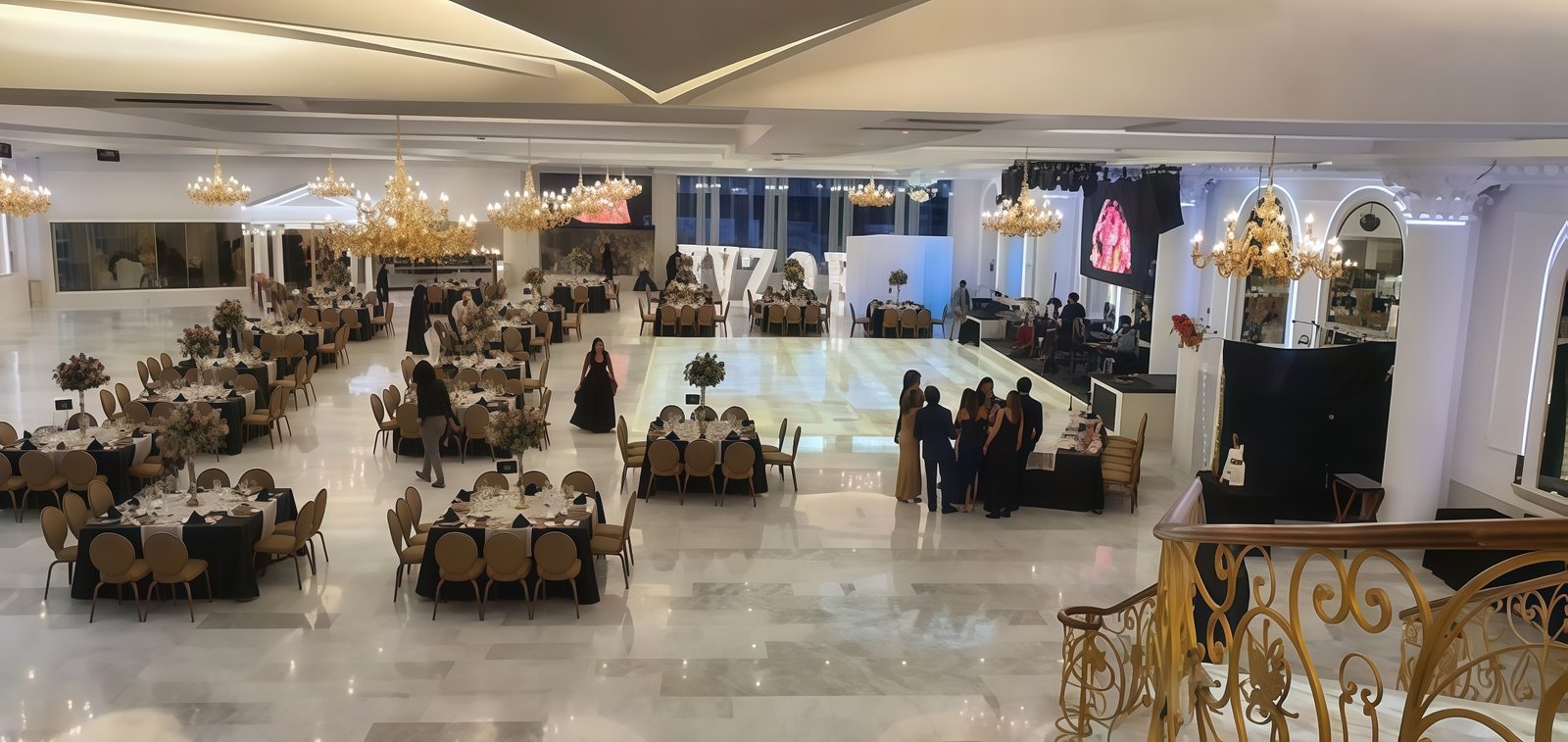 Salón Imperio decorated for a celebration with elegant tables and chairs, warm lighting creating a festive and welcoming atmosphere, Monarquía Coronado text visible on a sign, conveying a joyful and special event